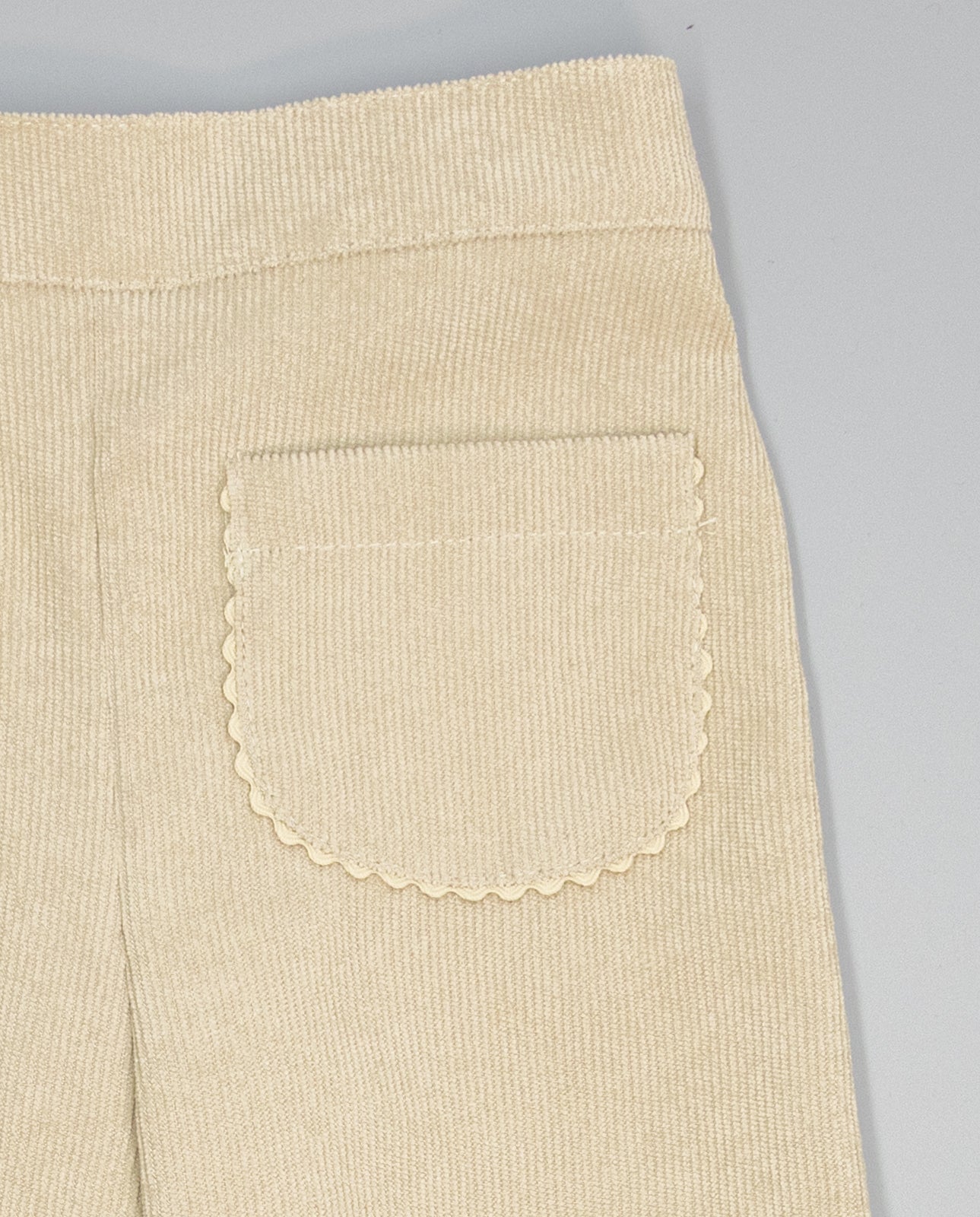 Girl corduroy trousers with patch pockets and ric-rac trim