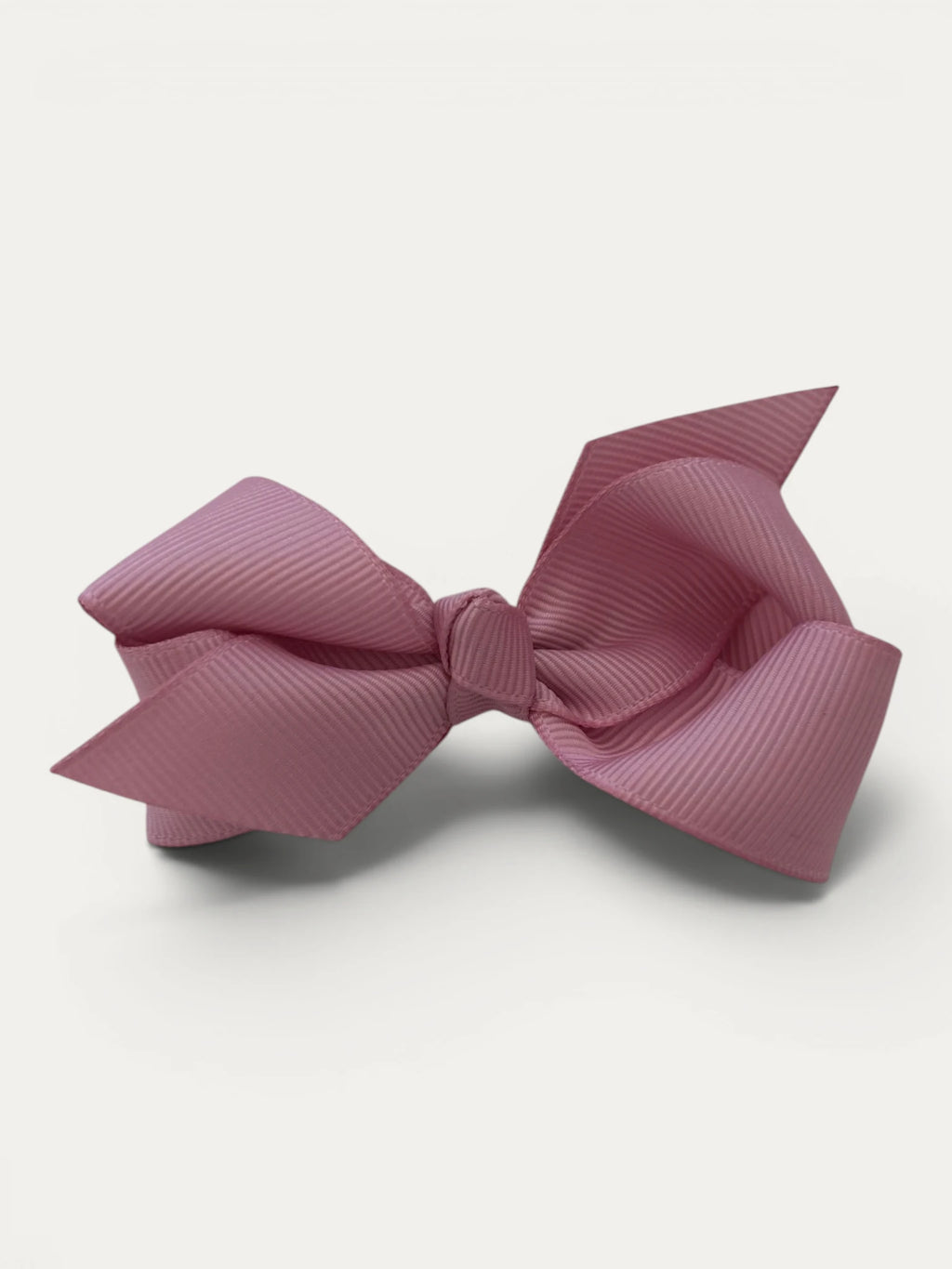 Fine grosgrain bow hair clip for girls; elegant texture, feminine silhouette, made in Spain and shipped from Switzerland.