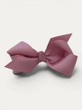 Fine grosgrain bow hair clip for girls; elegant texture, feminine silhouette, made in Spain and shipped from Switzerland.