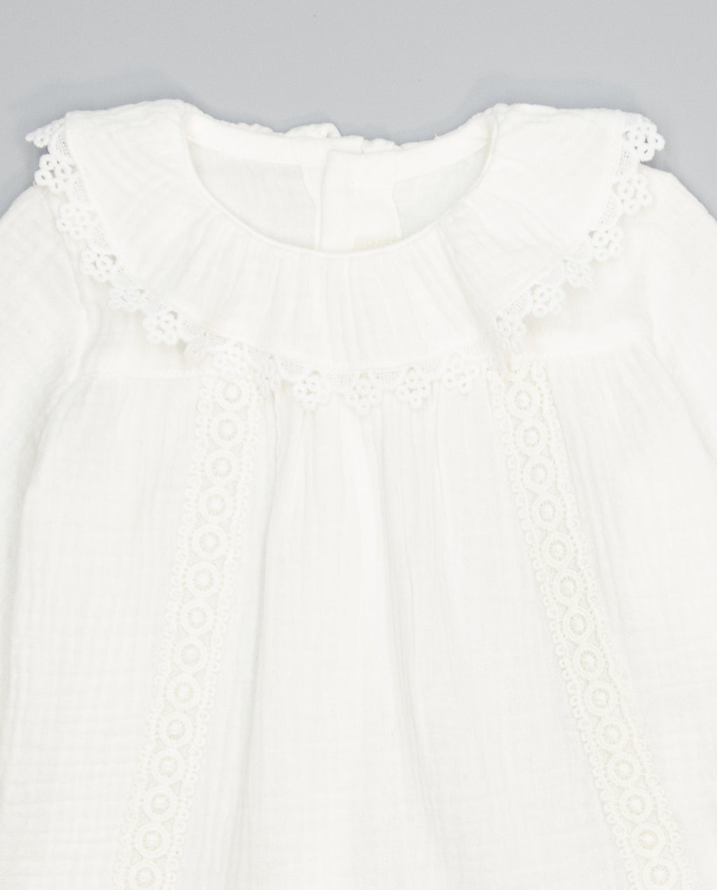 White structured cotton blouse with ruffled front and lace inserts