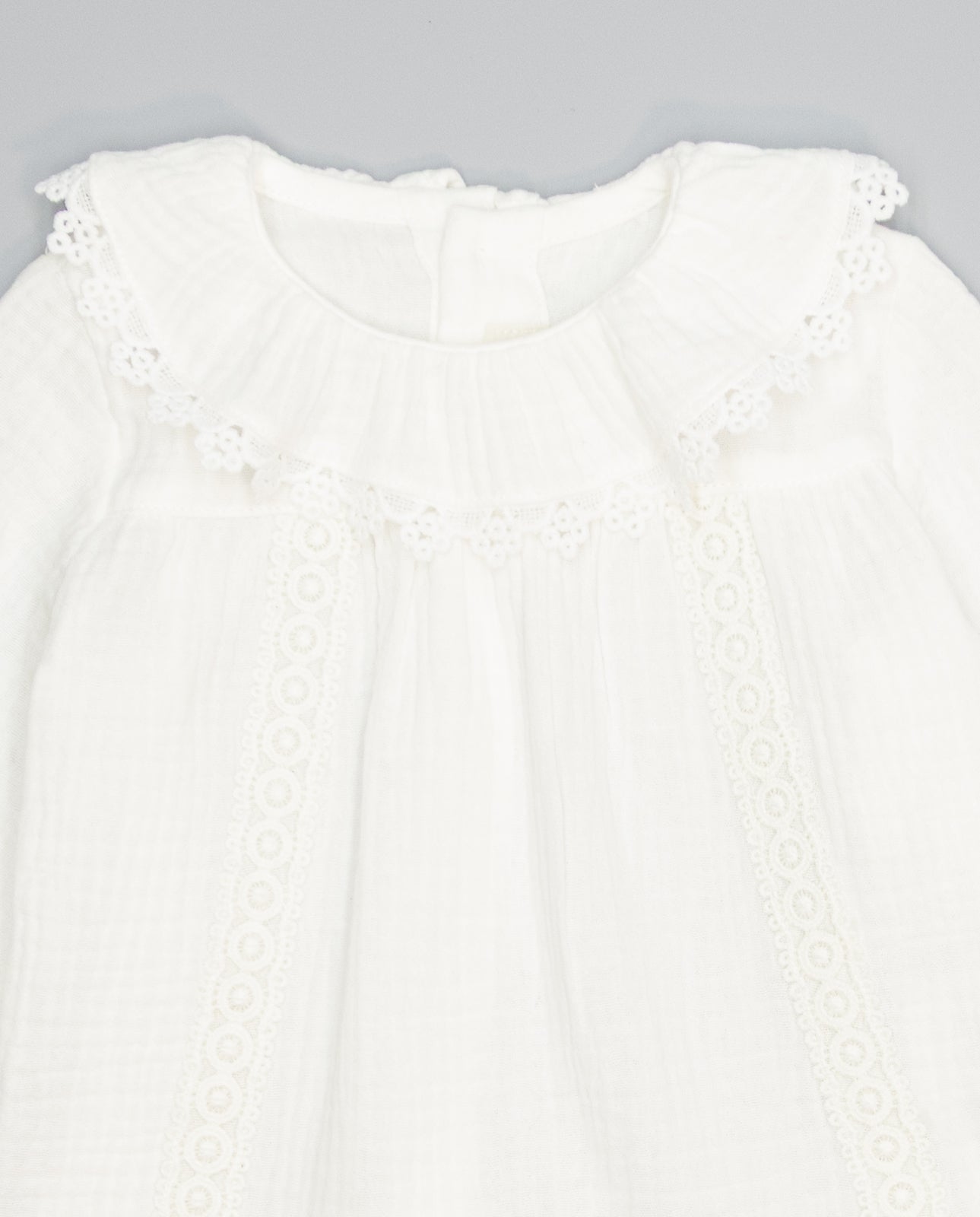 White structured cotton blouse with ruffled front and lace inserts