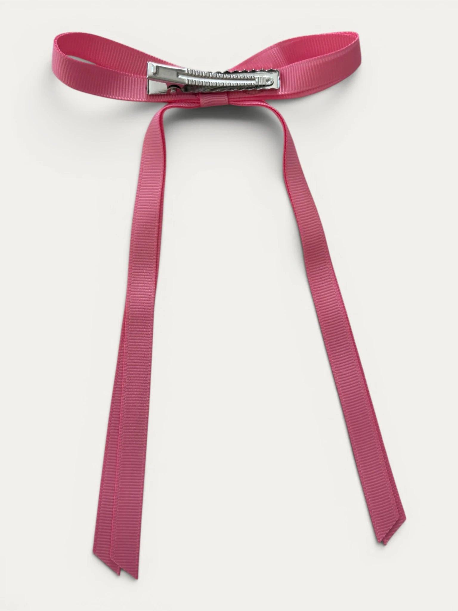 Classic long grosgrain bow clip for girls in Light Fuchsia; soft bright tone, elegant silhouette, made in Spain and shipped from Switzerland.