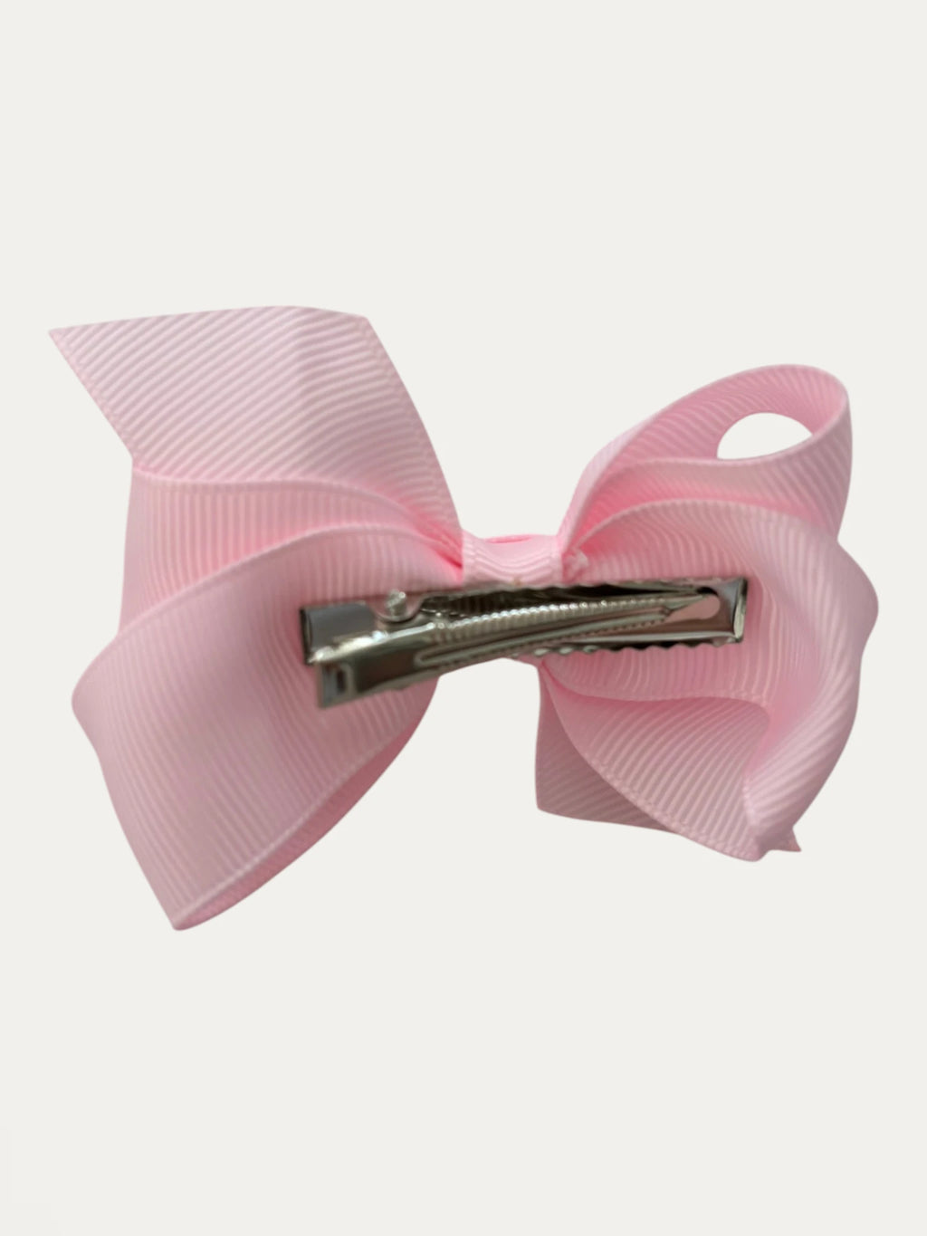 Fine grosgrain bow hair clip for girls; elegant texture, feminine silhouette, made in Spain and shipped from Switzerland.