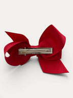 Fine grosgrain bow hair clip for girls; elegant texture, feminine silhouette, made in Spain and shipped from Switzerland.