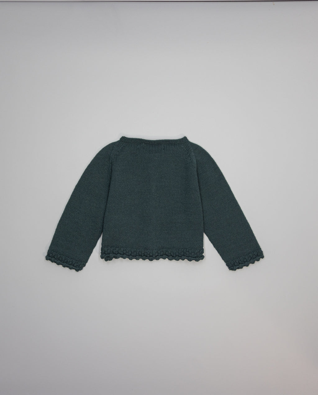 Dark green knitted kids cardigan with metallic bow and pearl initial button