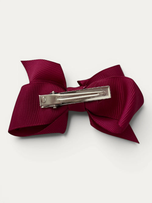 Burgundy fine grosgrain bow hair clip for girls; elegant texture, feminine silhouette, made in Spain and shipped from Switzerland.