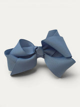 Light blue fine grosgrain bow hair clip for girls; elegant texture, feminine silhouette, made in Spain and shipped from Switzerland.