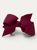 Fine grosgrain bow hair clip for girls; elegant texture, feminine silhouette, made in Spain and shipped from Switzerland.