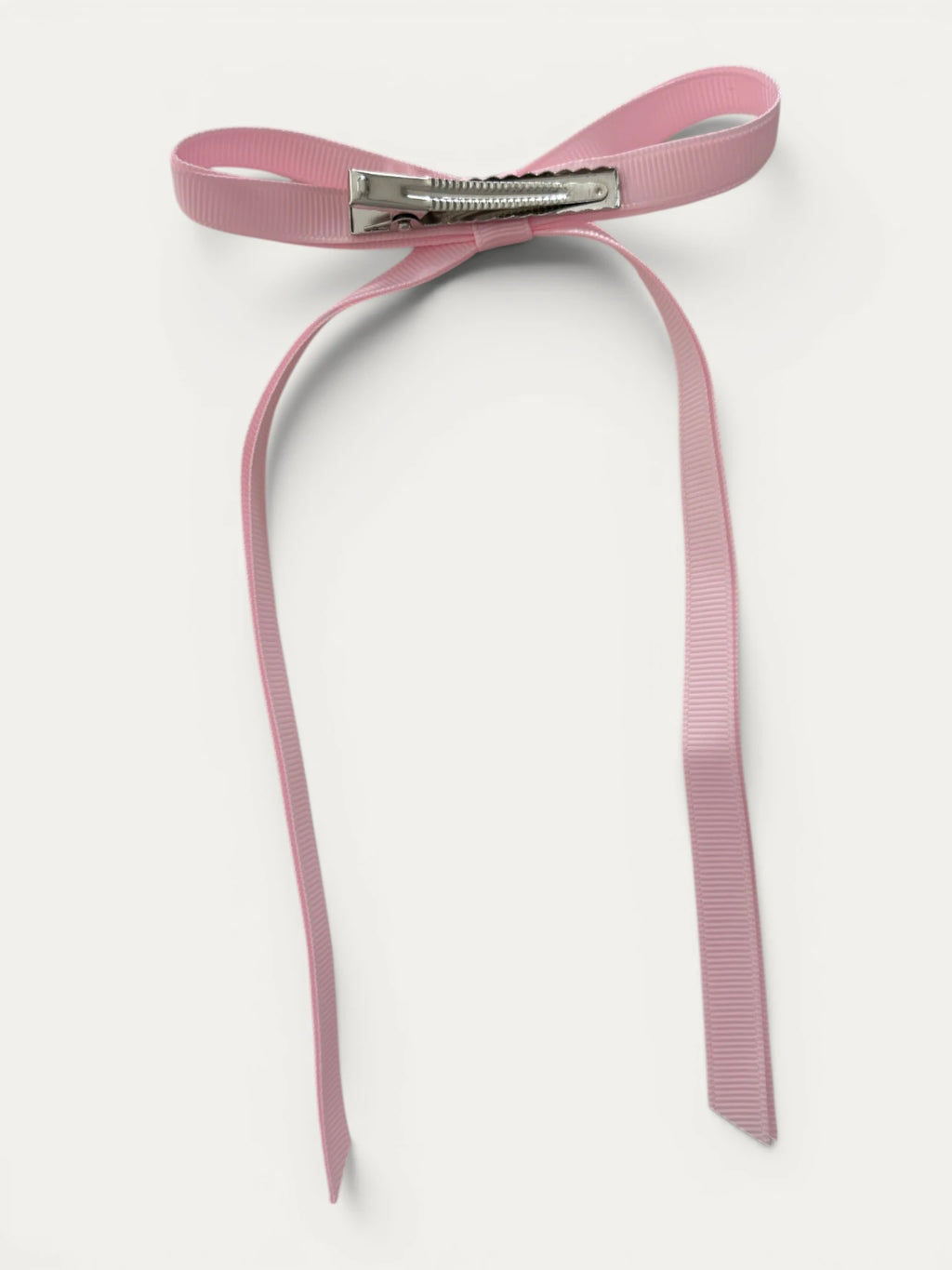 Classic long grosgrain bow clip for girls in Light Pink; pastel tone, elegant silhouette, made in Spain and shipped from Switzerland.