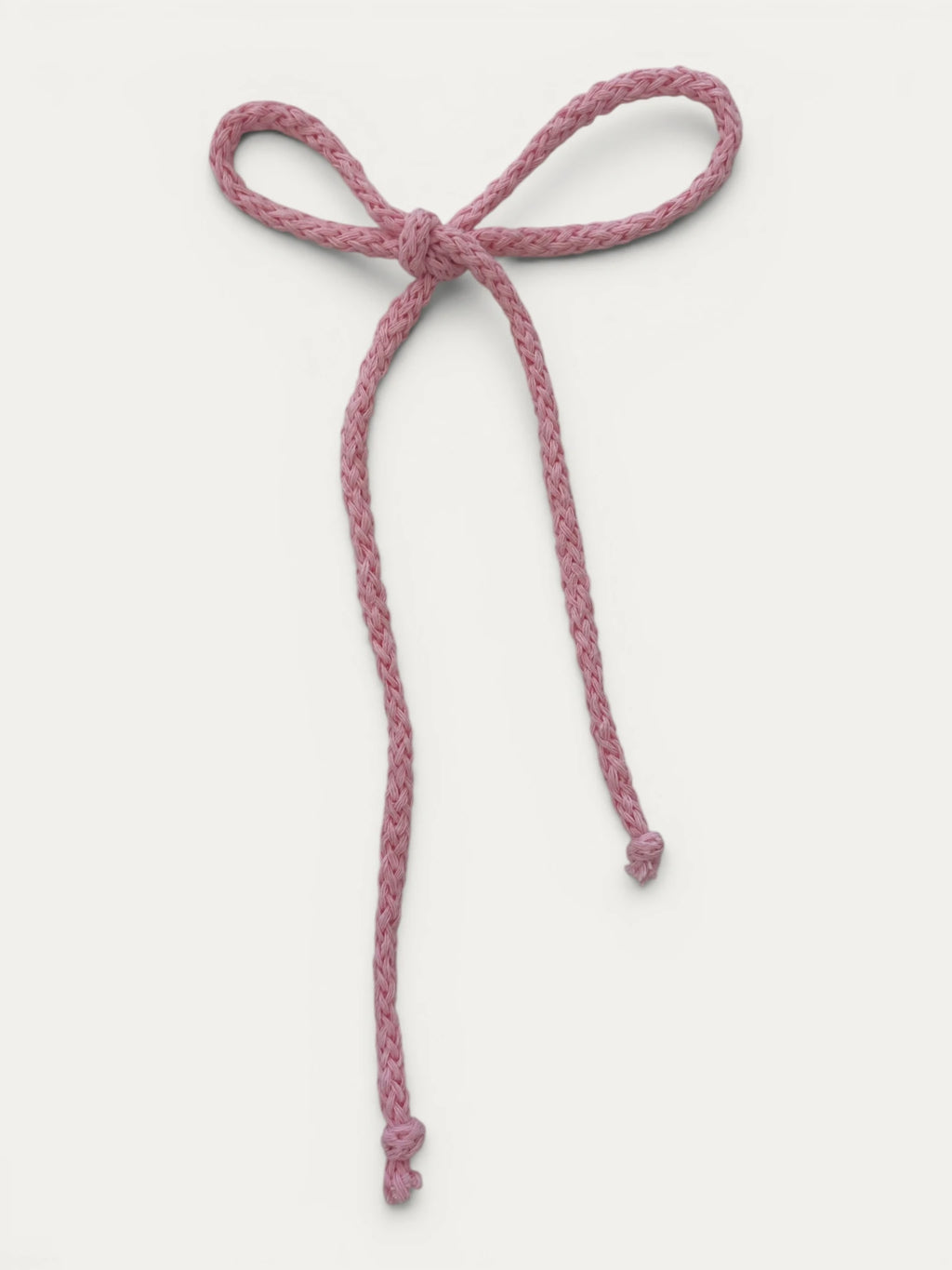 Long braided cotton hair cord for girls in Light Pink; soft pastel tone, elegant braided design, made in Spain and shipped from Switzerland.