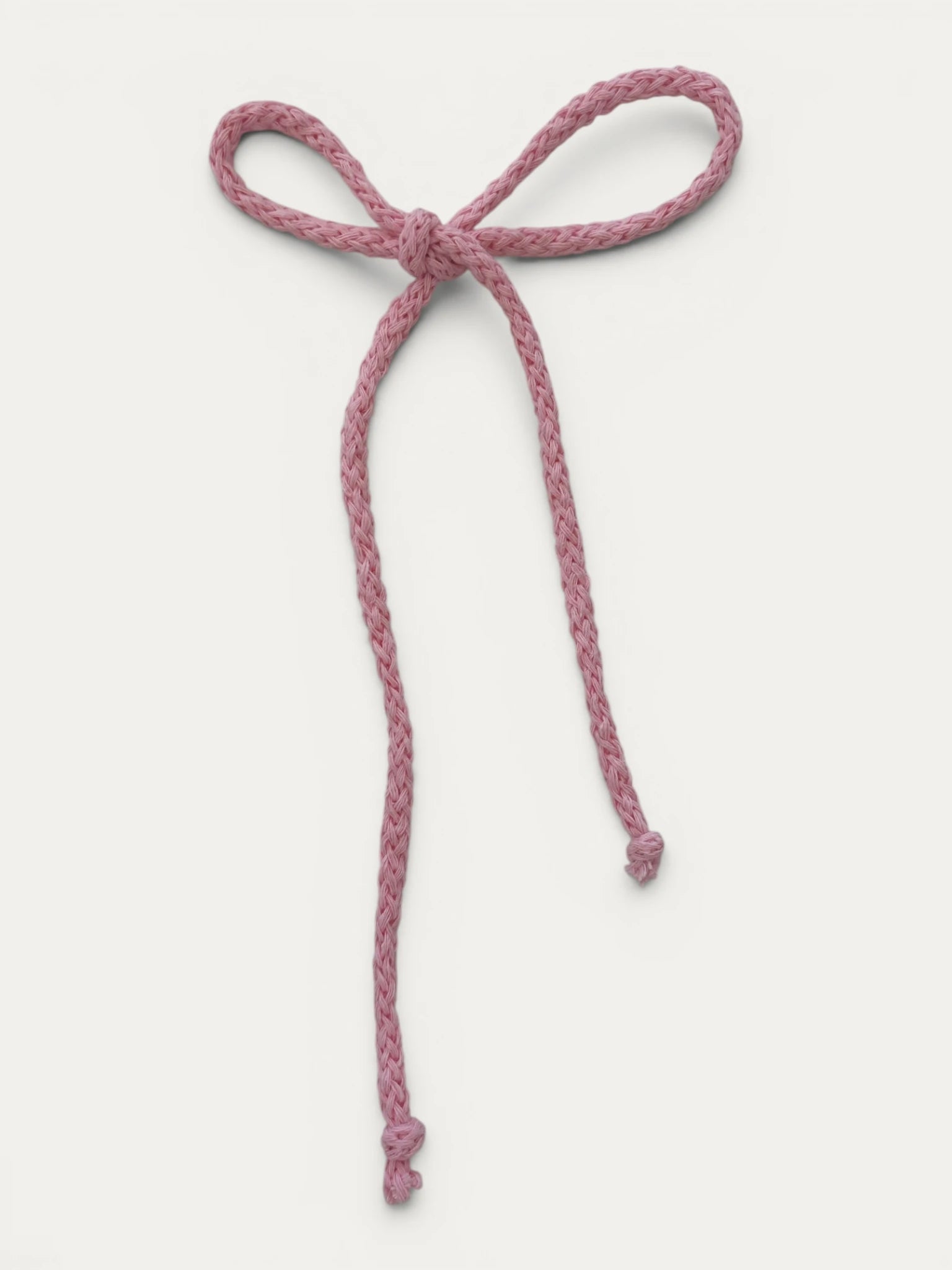 Long braided cotton hair cord for girls in Light Pink; soft pastel tone, elegant braided design, made in Spain and shipped from Switzerland.