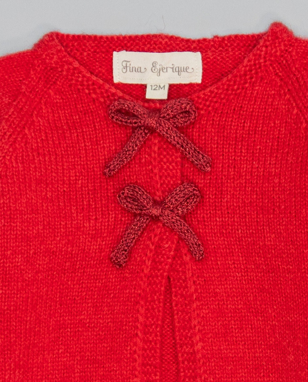Red knitted kids cardigan with metallic bow and pearl initial button