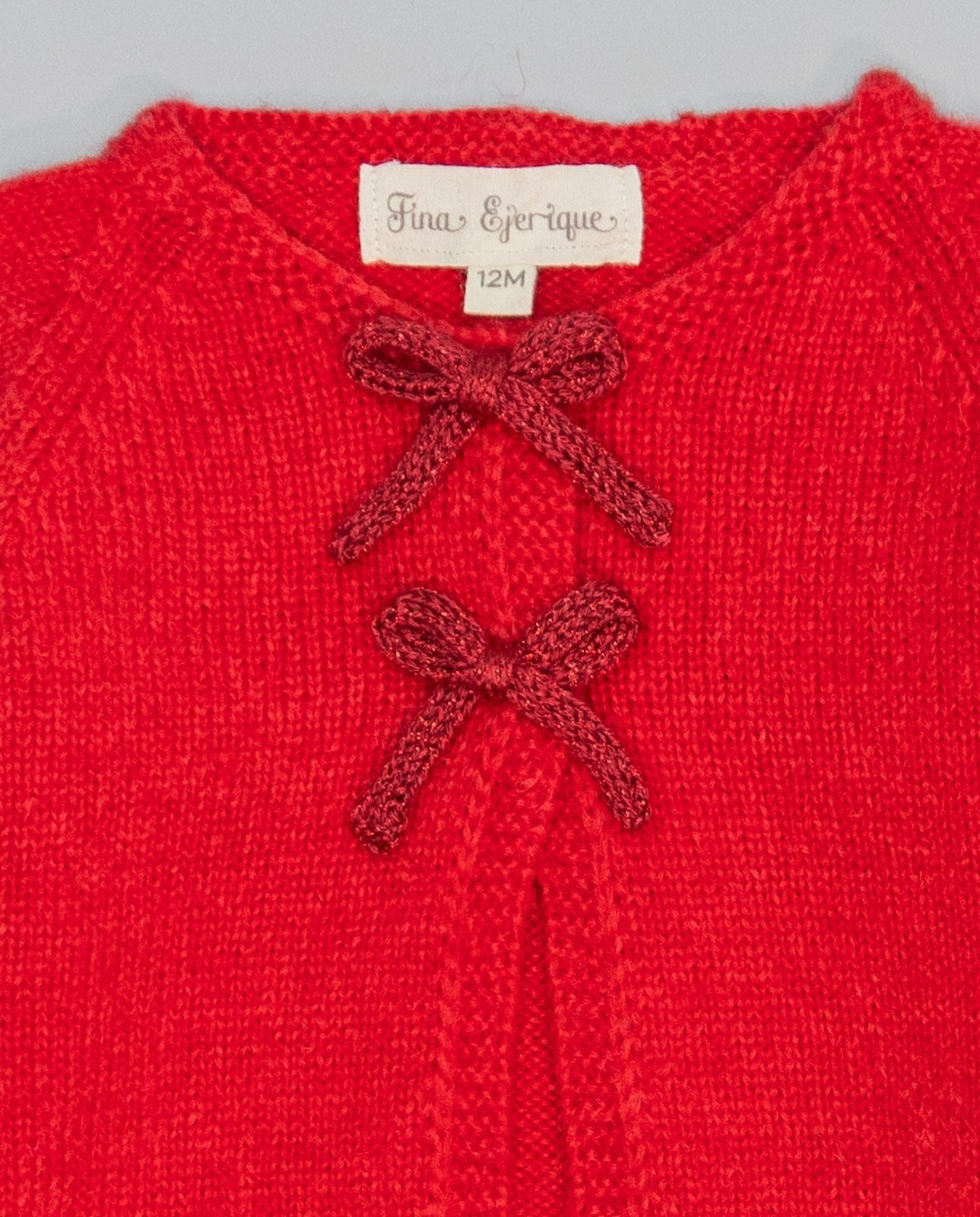 Red knitted kids cardigan with metallic bow and pearl initial button