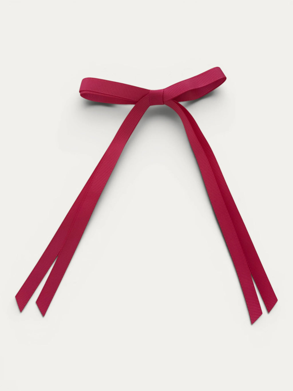 Classic long grosgrain bow clip for girls in Fuchsia; vibrant tone, elegant silhouette, made in Spain and shipped from Switzerland.