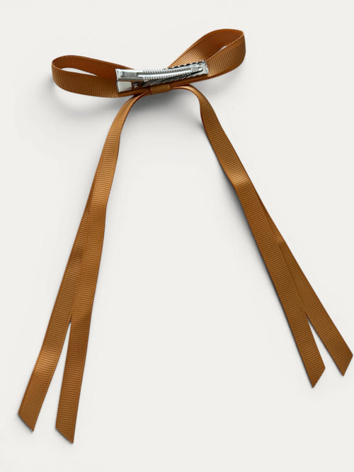 Classic long grosgrain Curry bow clip for girls in Curry; warm tone, elegant silhouette, made in Spain and shipped from Switzerland.