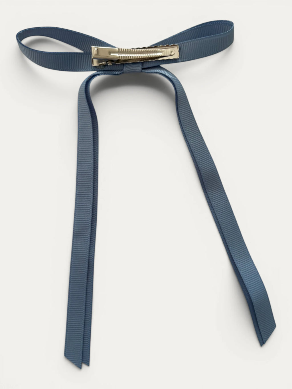 Classic long grosgrain bow clip for girls in French Blue; elegant silhouette, made in Spain and shipped from Switzerland.