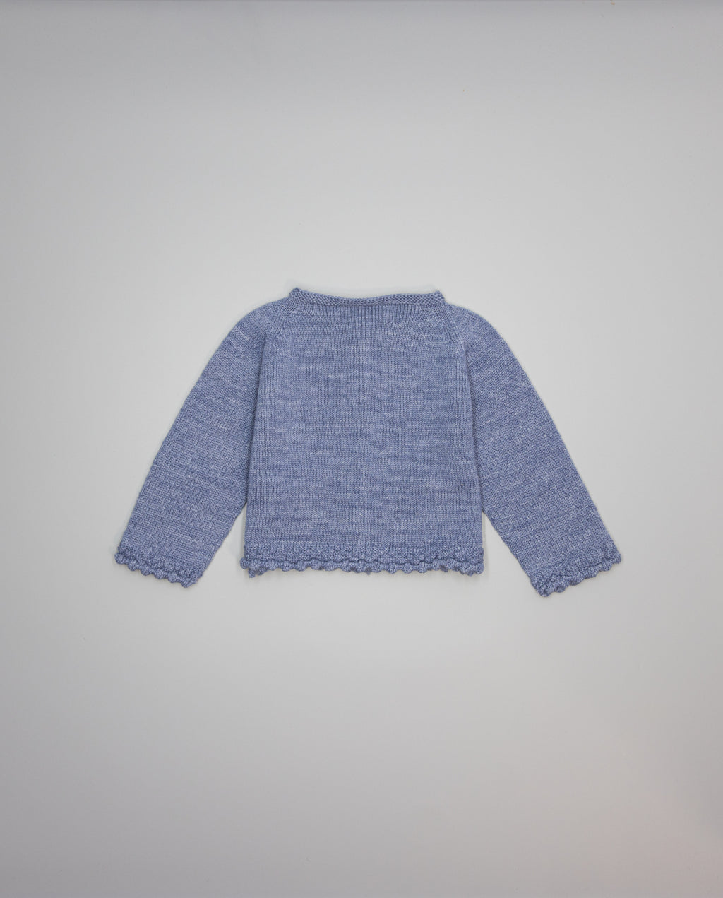 Blue knitted kids cardigan with metallic bow and pearl initial button