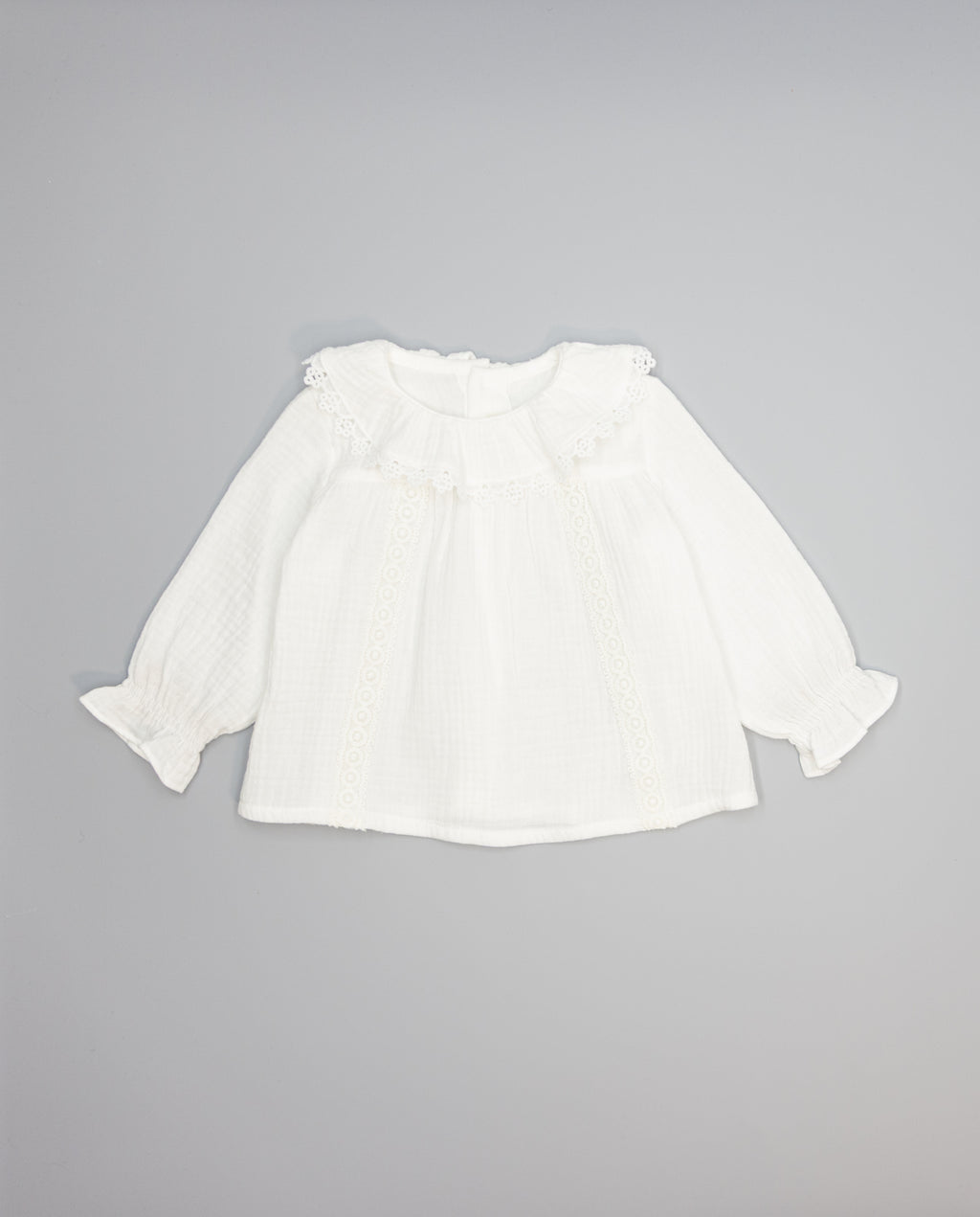 White structured cotton blouse with ruffled front and lace inserts