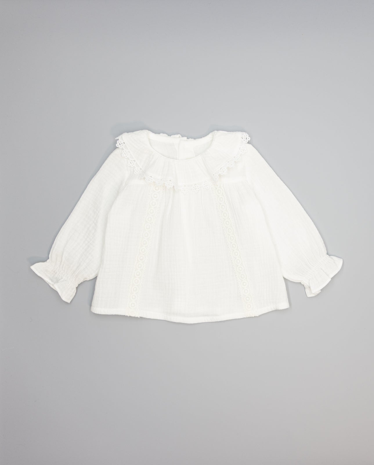White structured cotton blouse with ruffled front and lace inserts