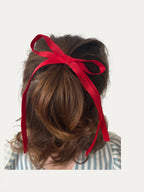 Classic long grosgrain bow clip for girls in Red; bright tone, elegant silhouette, made in Spain and shipped from Switzerland.