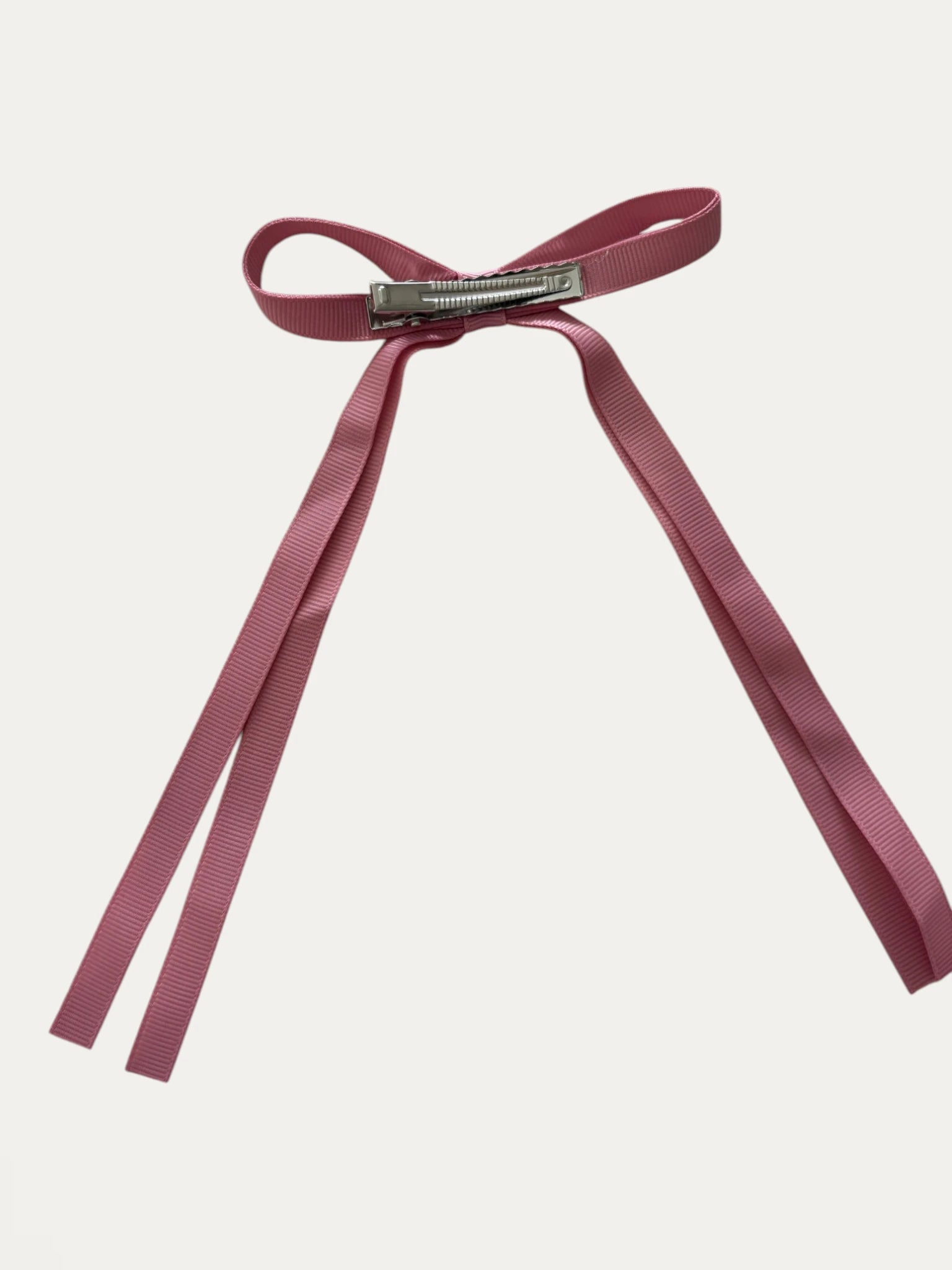 Classic long grosgrain bow clip for girls in French Rose; soft tone, elegant silhouette, made in Spain and shipped from Switzerland.