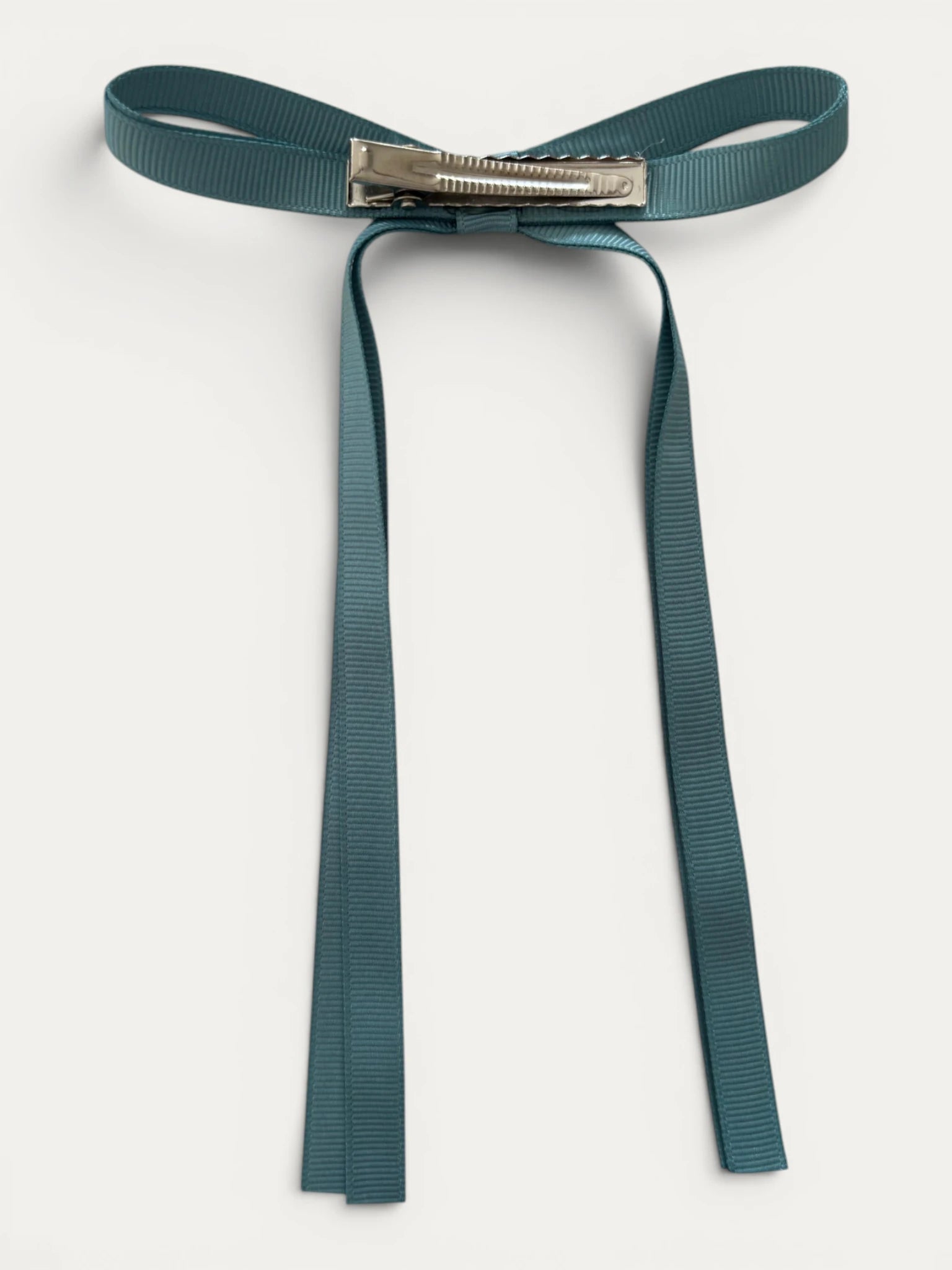 Classic long grosgrain bow clip for girls in Blue Moss; deep muted tone, elegant silhouette, made in Spain and shipped from Switzerland.