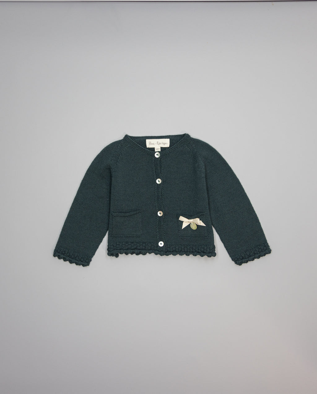 Dark green knitted kids cardigan with metallic bow and pearl initial button