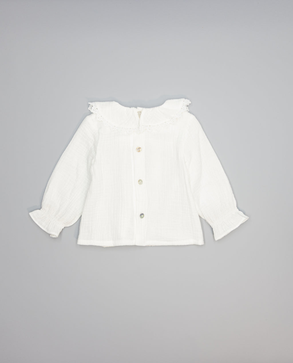 White structured cotton blouse with ruffled front and lace inserts