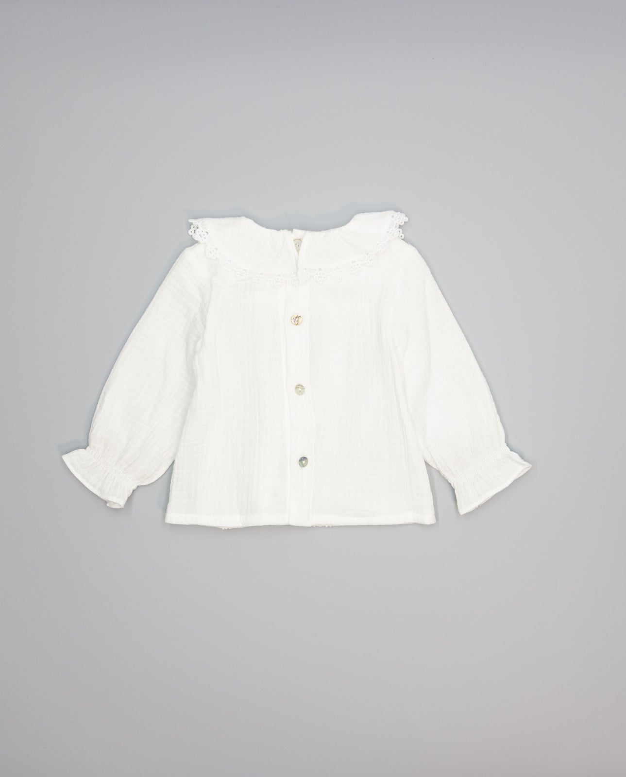 White structured cotton blouse with ruffled front and lace inserts
