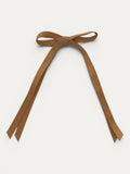 Classic long grosgrain bow clip for girls in Curry; warm tone, elegant silhouette, made in Spain and shipped from Switzerland.