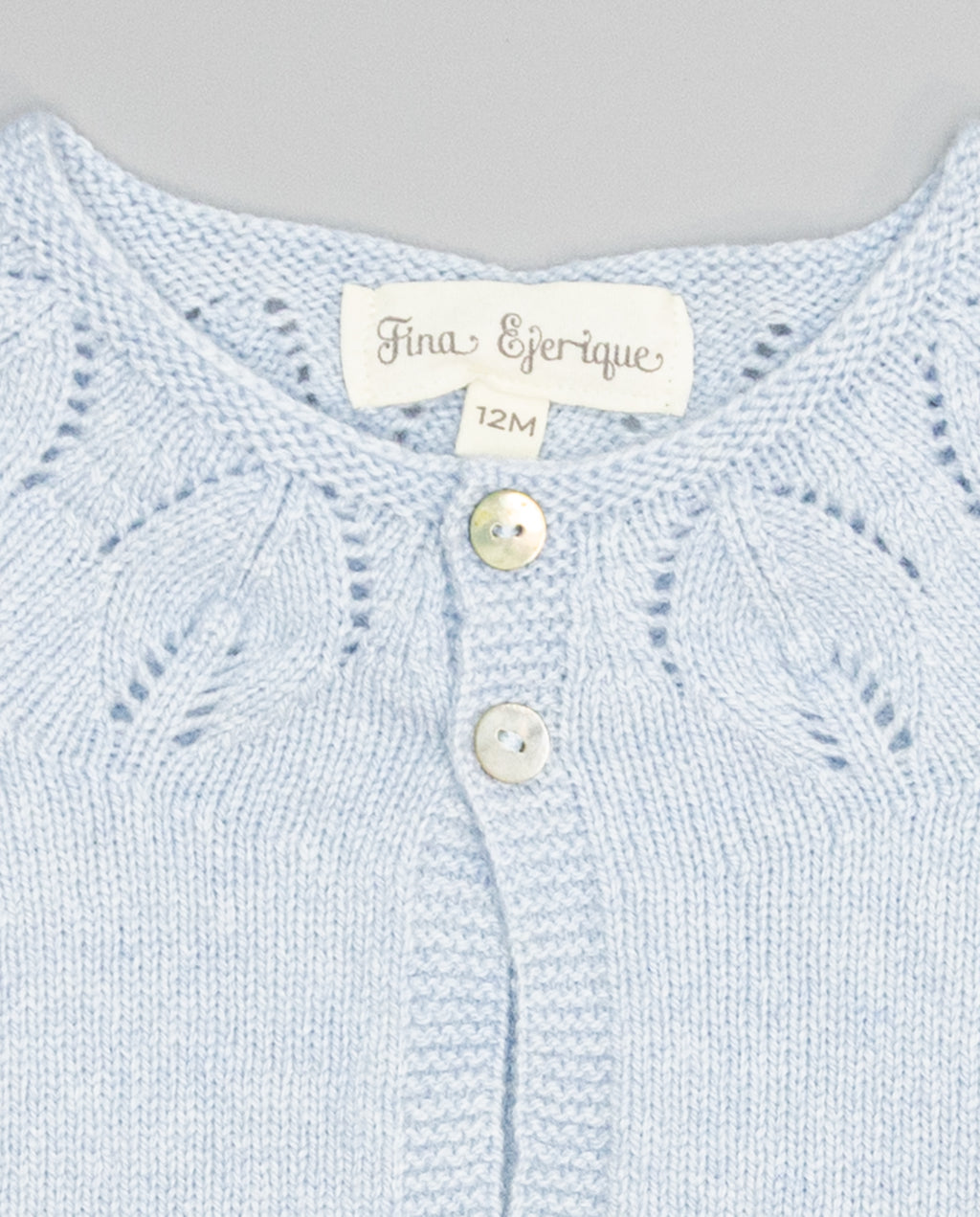 blue girls cashmere cardigan with eyelets and pearl buttons
