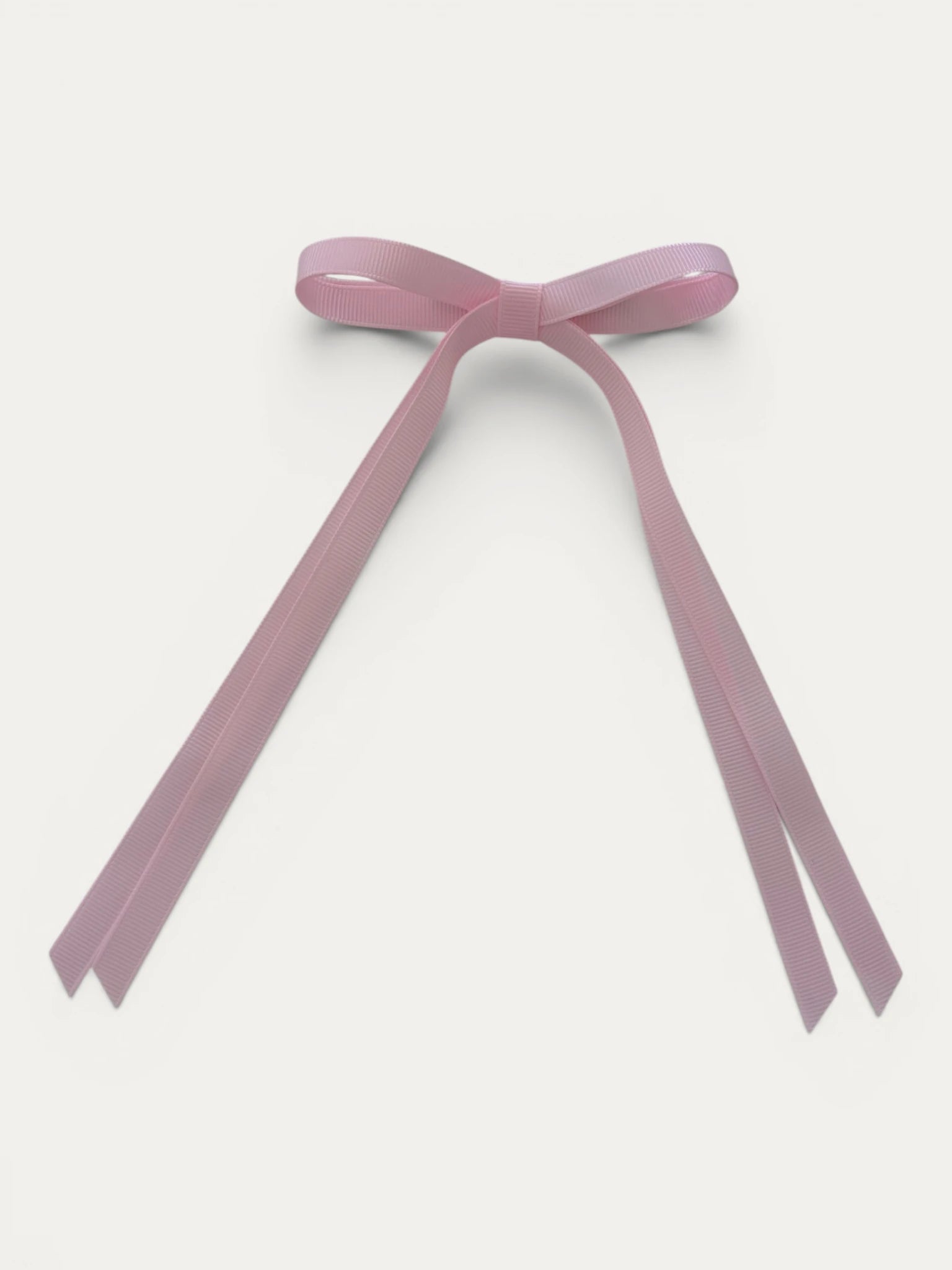 Classic long grosgrain bow clip for girls in Light Pink; pastel tone, elegant silhouette, made in Spain and shipped from Switzerland.