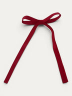 Classic long grosgrain bow clip for girls in Red; bright tone, elegant silhouette, made in Spain and shipped from Switzerland.
