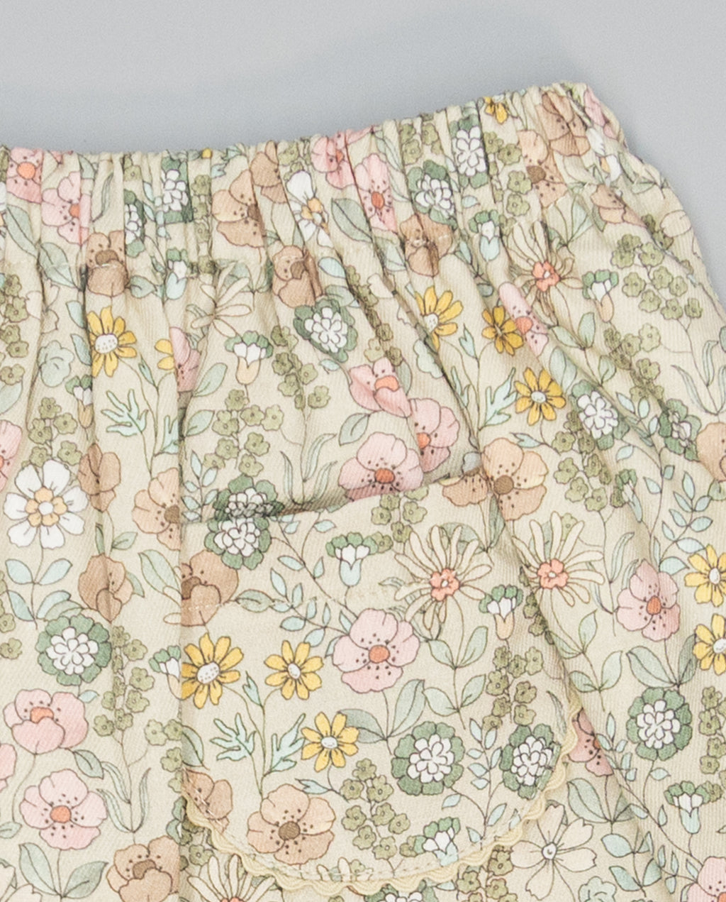 Beige floral viella gathered skirt with pockets trimmed in beige piping
