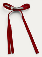 Classic long grosgrain bow clip for girls in Red; bright tone, elegant silhouette, made in Spain and shipped from Switzerland.
