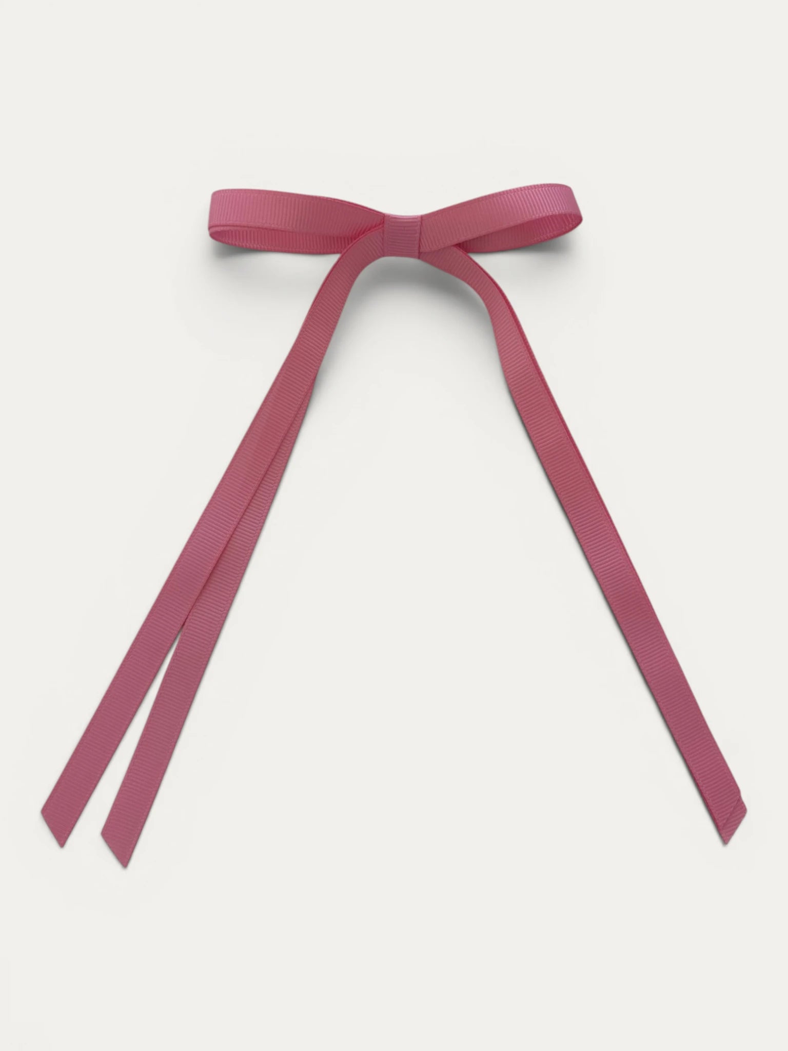 Classic long grosgrain bow clip for girls in Light Fuchsia; soft bright tone, elegant silhouette, made in Spain and shipped from Switzerland.