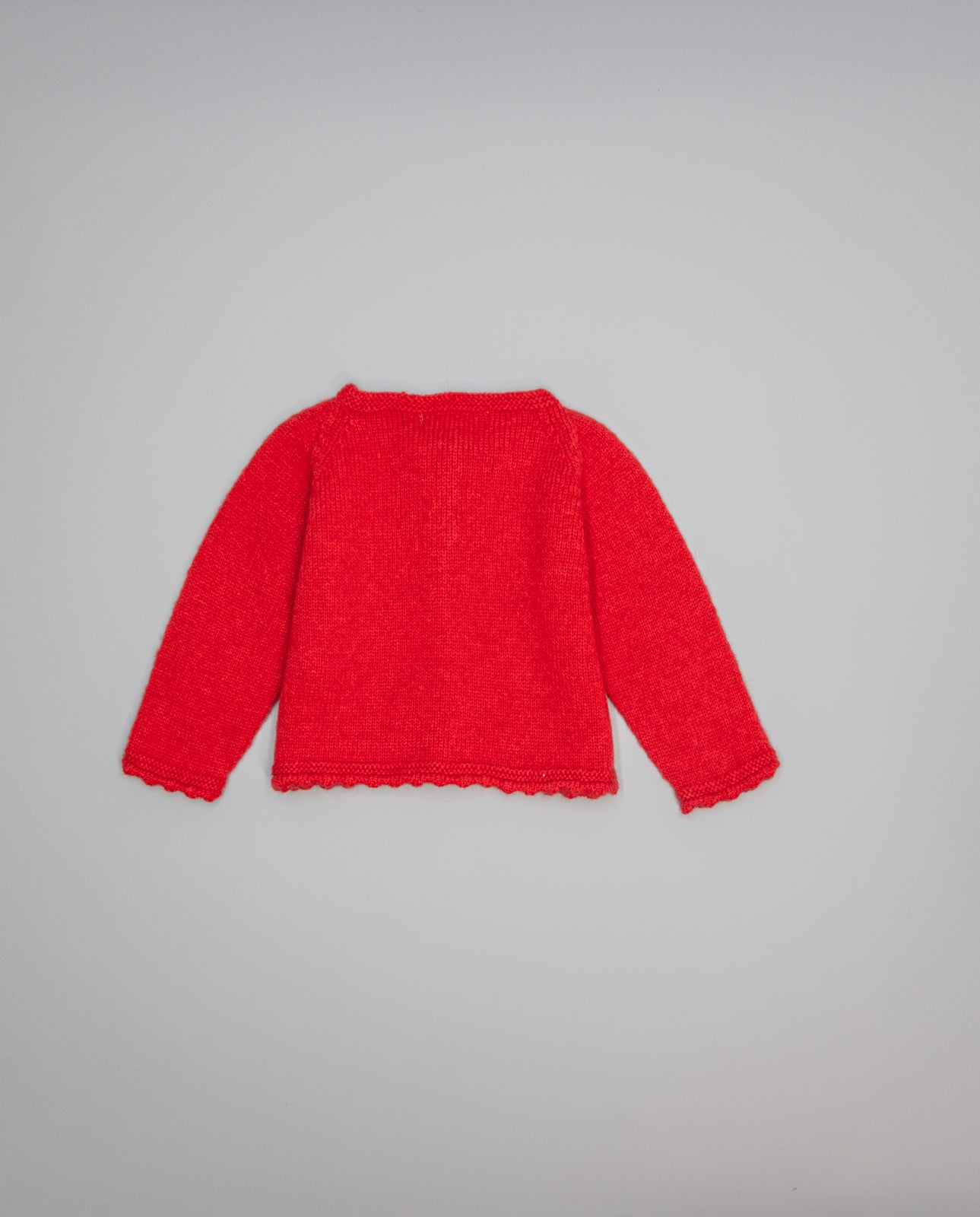 Red knitted kids cardigan with metallic bow and pearl initial button