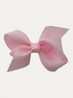 Fine grosgrain bow hair clip for girls; elegant texture, feminine silhouette, made in Spain and shipped from Switzerland.